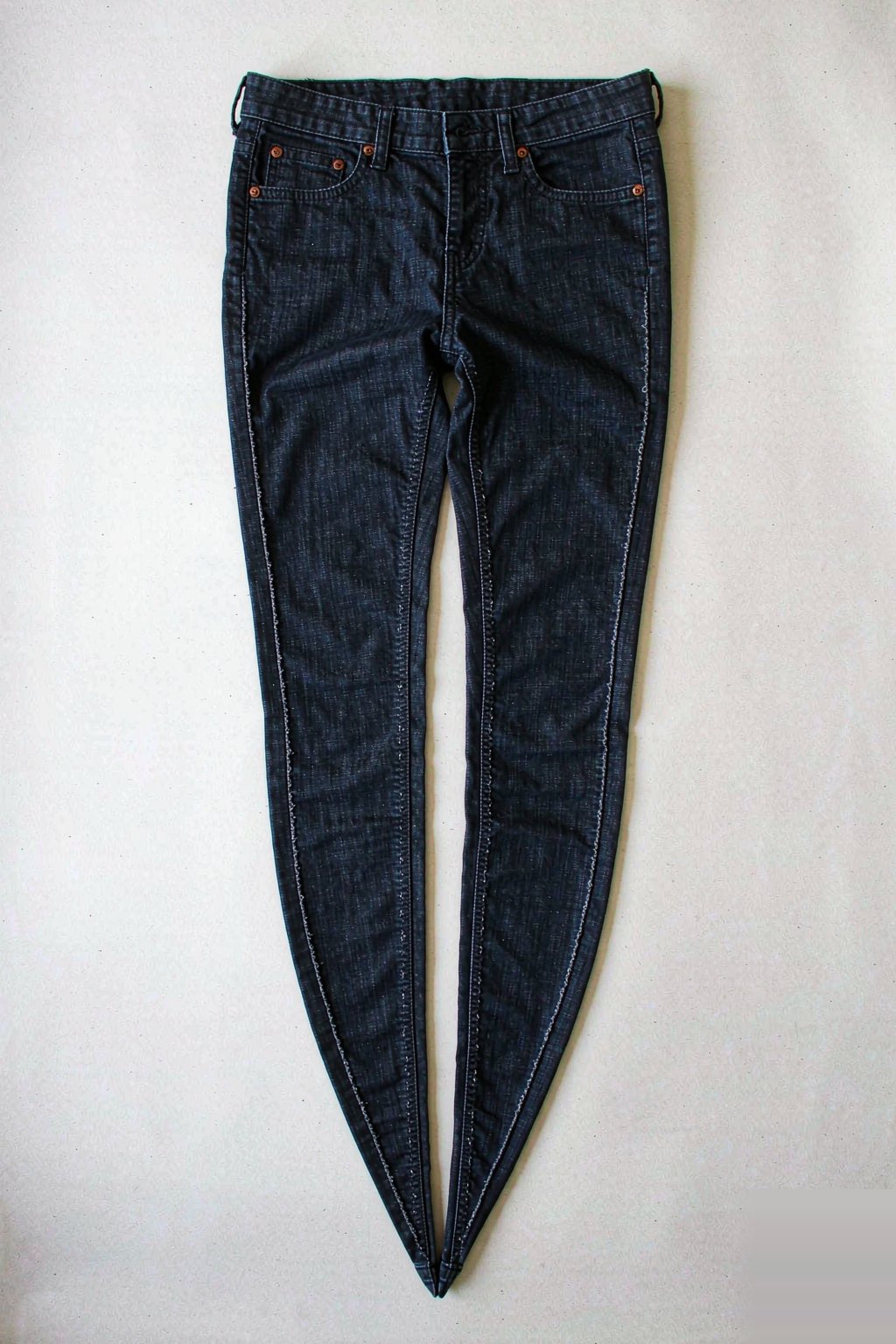 The Eight Fits The Mid-Rise Skinny Jean — Dark Indigo laid flat, showing the leg opening and rise